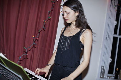 Young woman playing a keyboard