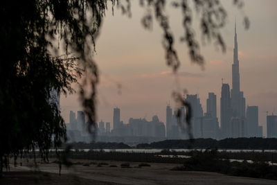 Buildings in city at sunset