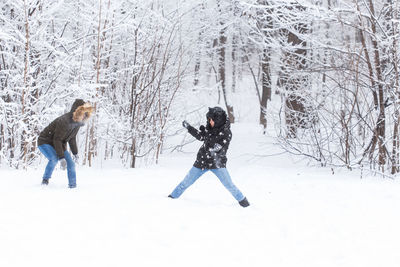 Woman standing on snow covered land