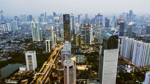 Aerial view of modern buildings in city against sky