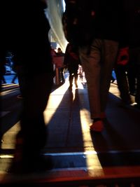 Low section of people walking on railroad station platform