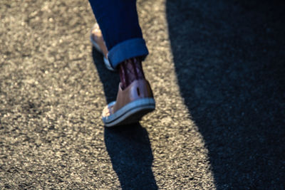 Low section of woman wearing shoes