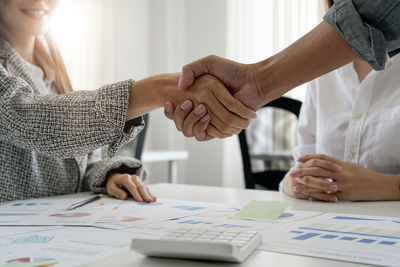 Midsection of business colleagues working at office