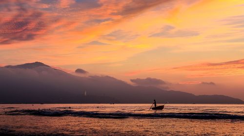 Scenic view of sea against orange sky