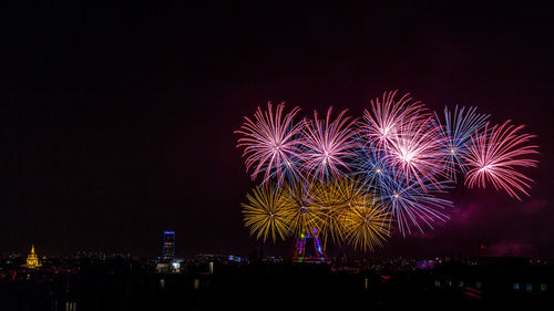 Firework display against clear sky at night