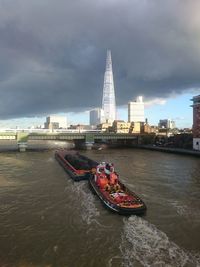 Boat in river with buildings in background