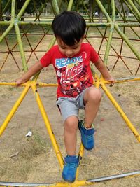 Full length of cute boy playing on playground