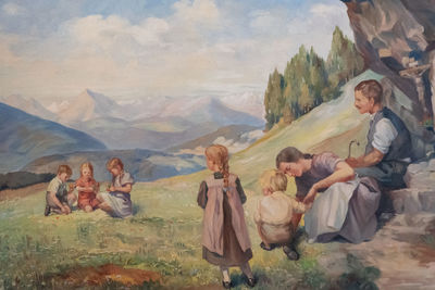 Group of people on mountain range against sky