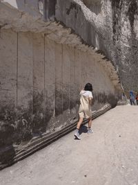 Woman are walking in view of a limestone wall