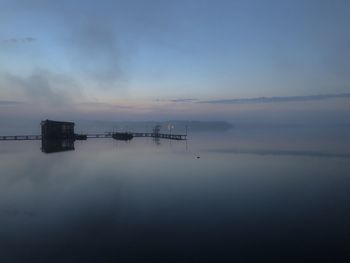 Scenic view of lake against sky during sunset