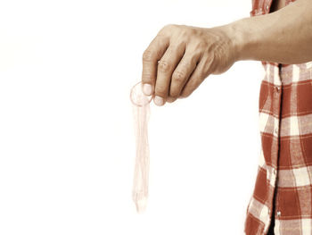 Close-up of person hand against white background