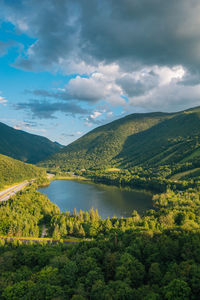 Scenic view of lake and mountains against sky