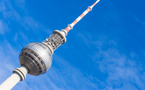 Low angle view of communications tower against blue sky