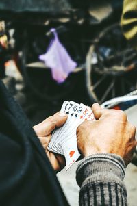 Extreme close up of hands holding playing cards