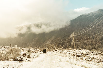 Scenic view of snow covered mountains against sky