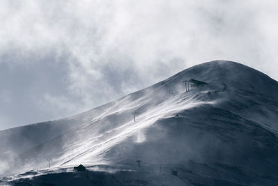 Aerial view of snowcapped mountain against sky