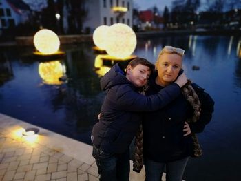 Full length of mother and daughter in park during winter