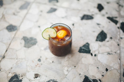 High angle view of drink in glass on floor