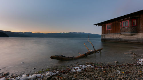 Scenic view of sea by buildings against sky