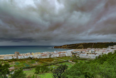 Panoramic view of townscape by sea against sky