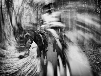 Blurred motion of person riding bicycle on road