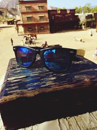 Close-up of sunglasses against buildings