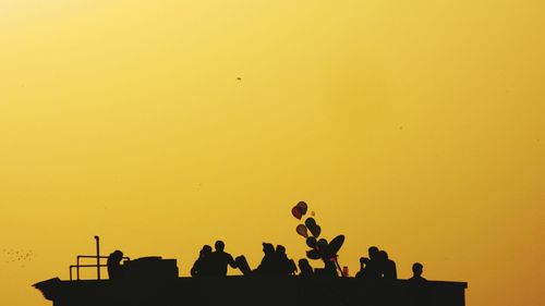 Low angle view of silhouette people enjoying at party during sunset
