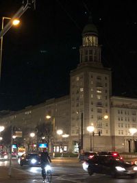 Illuminated city street and buildings at night