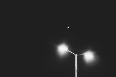 Low angle view of moon in sky at night