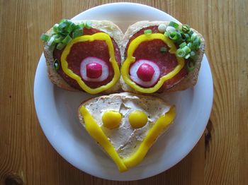 High angle view of anthropomorphic face made from bread and vegetables