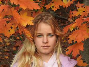 Portrait of girl on leaves during autumn