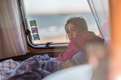 Close-up of girl sitting in caravan