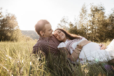 Young couple kissing on field