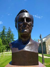 Low angle view of statue against blue sky