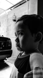 Close-up of crying baby boy standing in garage