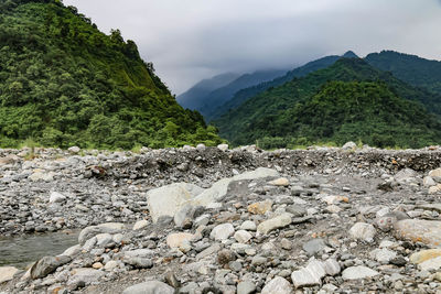 Scenic view of rocks and mountains against sky