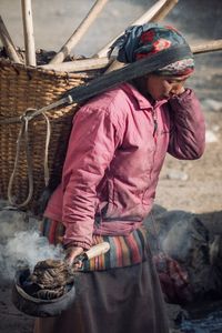 Side view of woman working in winter