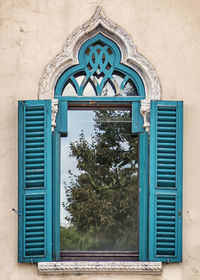 Typical venetian style window with nature reflected