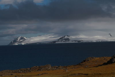Scenic view of snow covered mountains against sky