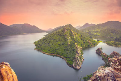 Scenic view of river amidst mountains against sky