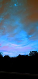 Scenic view of silhouette trees against sky at sunset