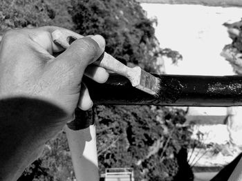 Close-up of hand holding cigarette