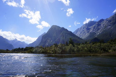 Scenic view of lake and mountains against sky