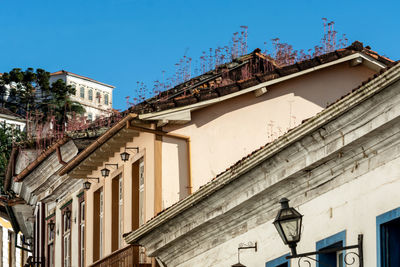 Low angle view of old building against clear blue sky