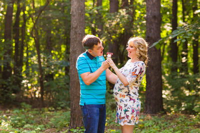 Full length of happy woman in forest