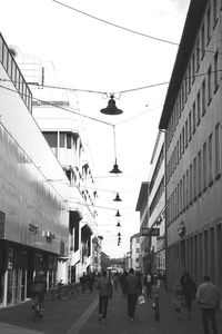 People walking on street in city against clear sky