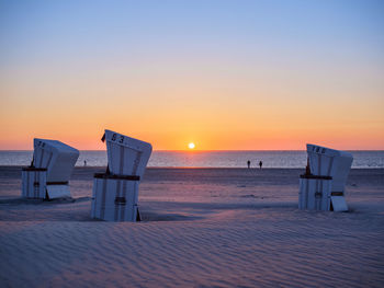 Scenic view of beach against sky during sunset
