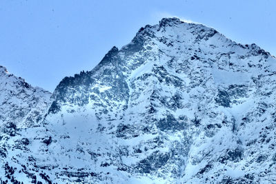 Scenic view of snowcapped mountains against clear blue sky