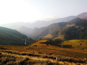 Scenic view of field and mountains against sky