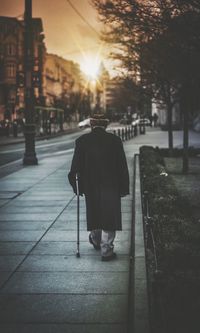 Rear view of a man walking on street